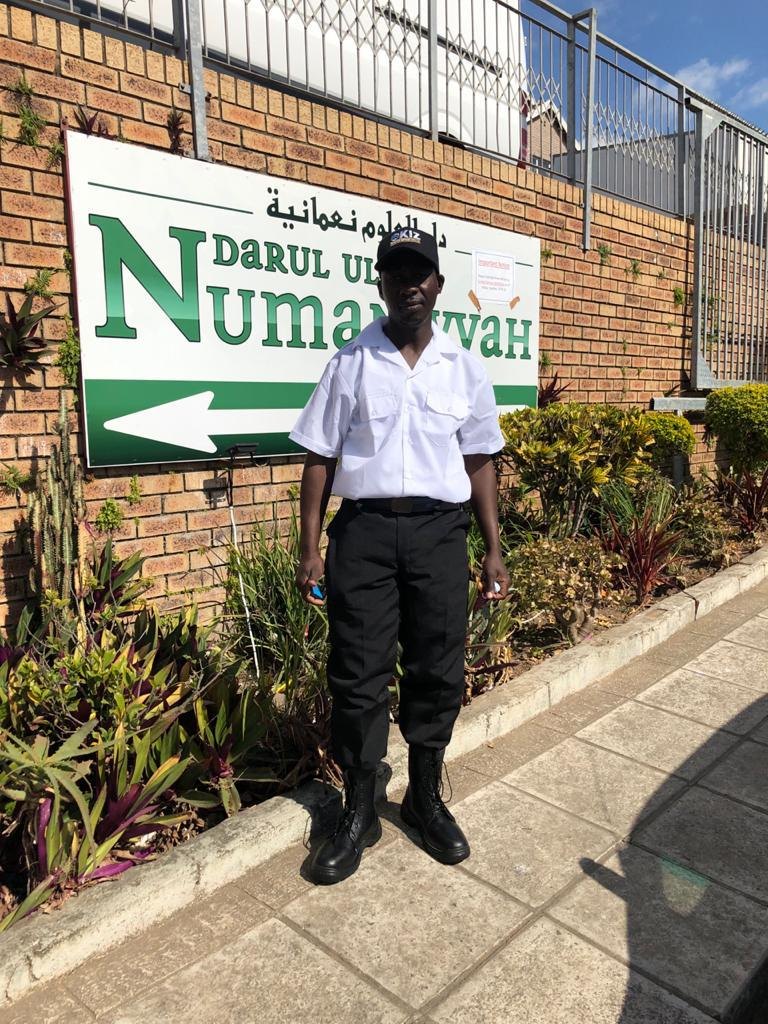 KIZ guard standing beside a branded vehicle