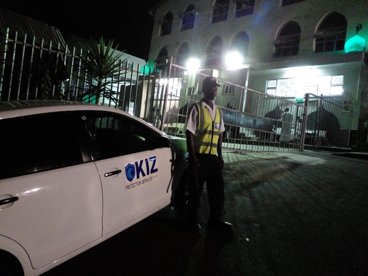 KIZ guard on night patrol beside a vehicle